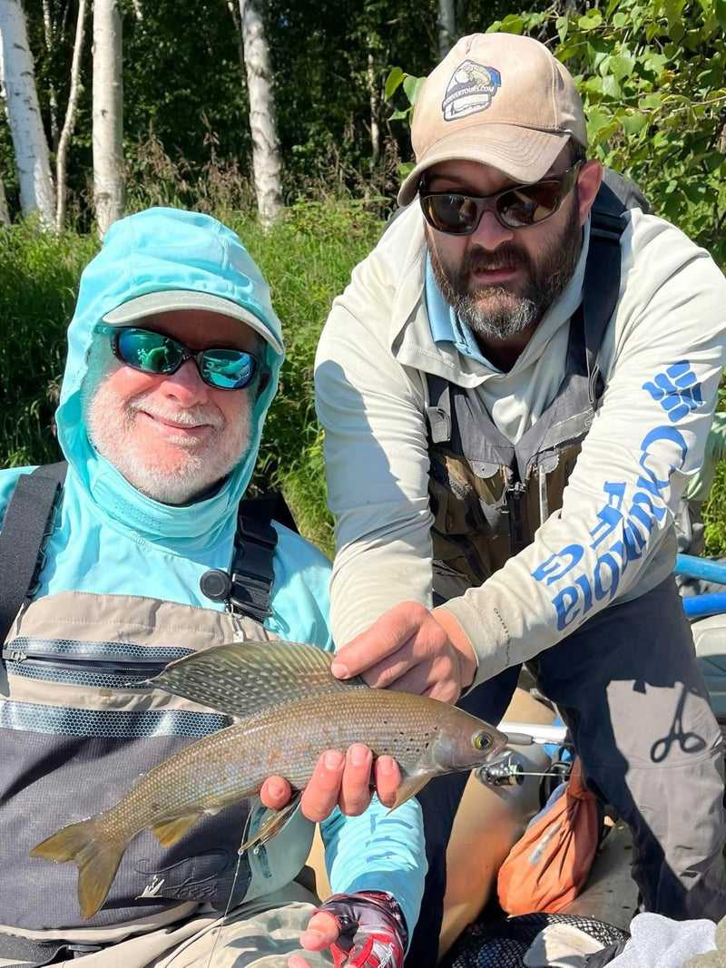 Richard Cross with an Alaska grayling caught on a chrome gray/white Zig Jig