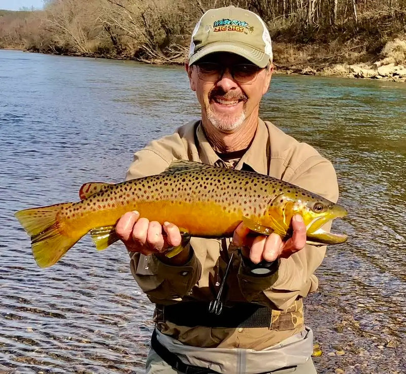 Angler holding a large trout
