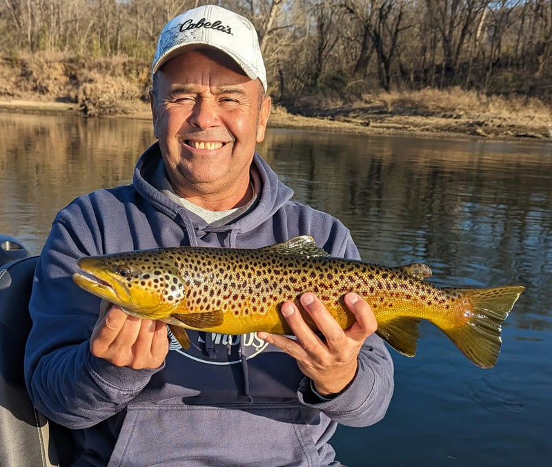 Angler holding a brown trout