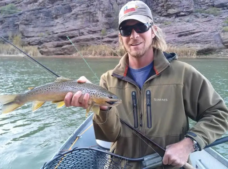 Angler holding a large trout