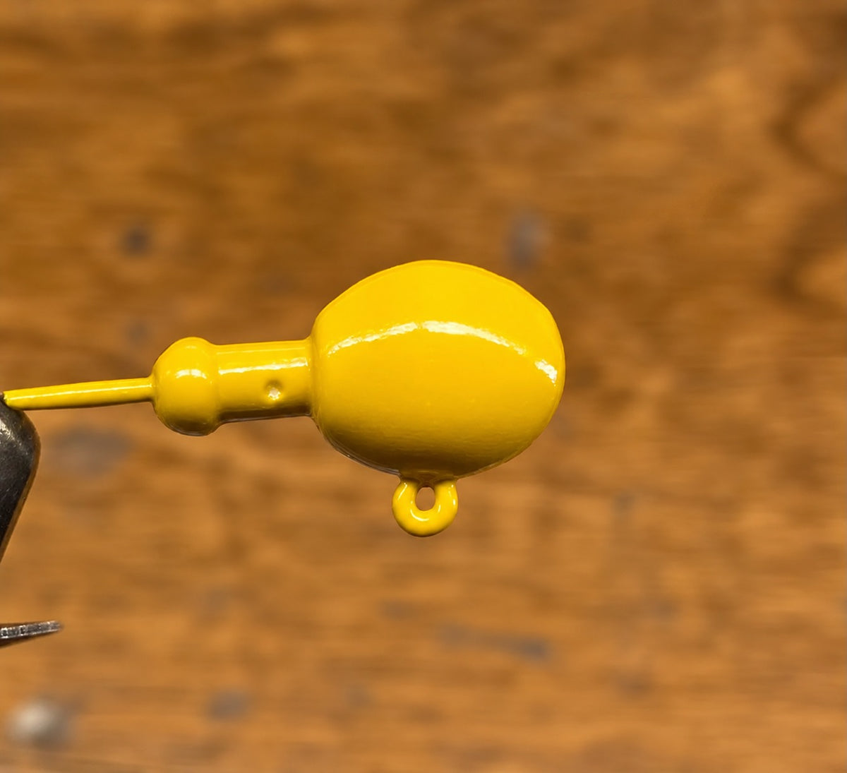 Mustard yellow Zig Jig head showing the offset head and eyelet
