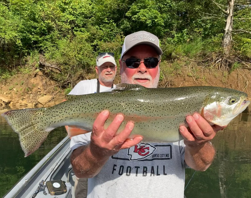 Angler holding a large rainbow trout