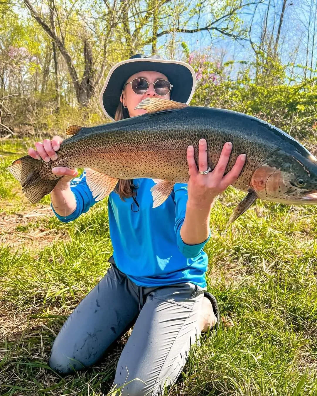 woman holding a large trout