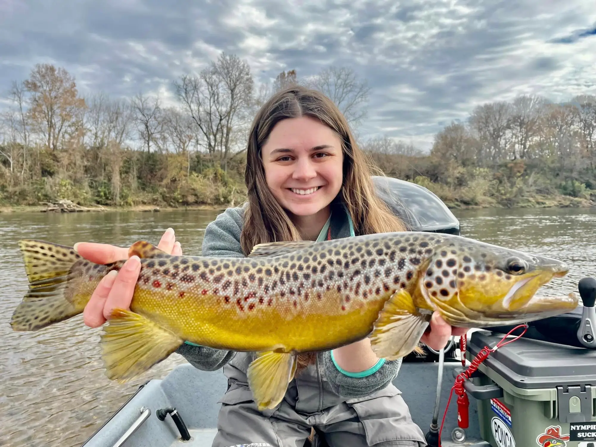 young girl holding a large trout